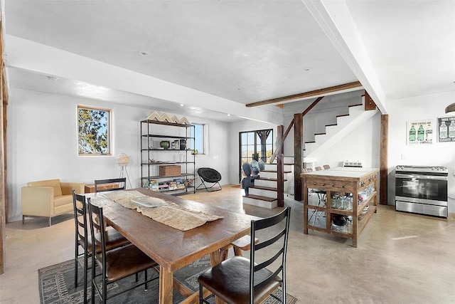 dining space featuring beamed ceiling