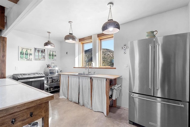 kitchen featuring stainless steel appliances, sink, and hanging light fixtures