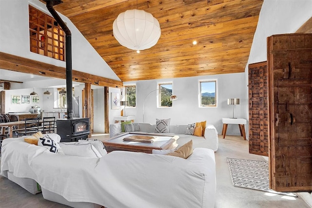 living room featuring wood ceiling, high vaulted ceiling, and a wood stove