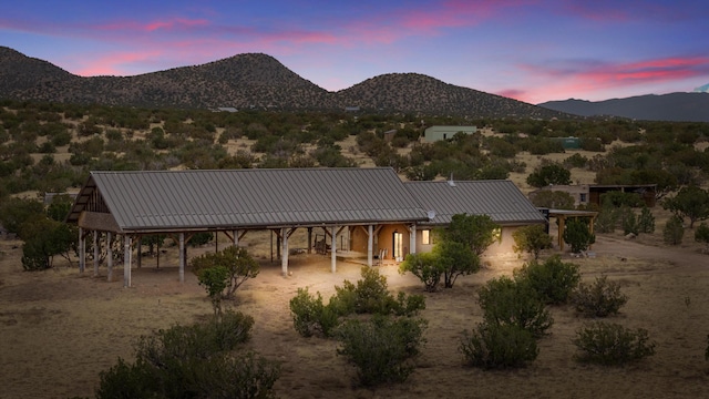 back house at dusk with a mountain view