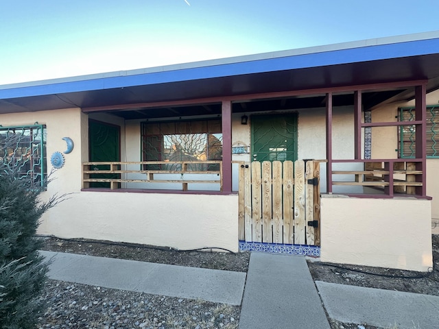 view of exterior entry featuring stucco siding