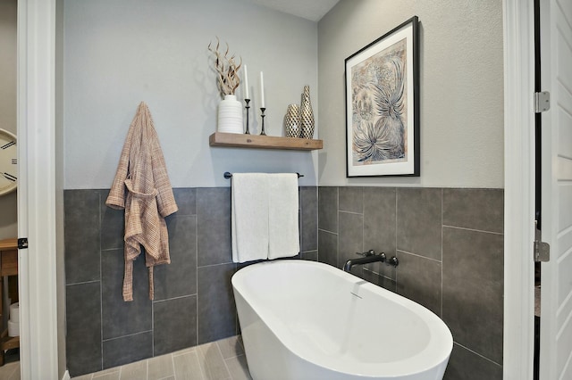 bathroom featuring tile walls and a tub