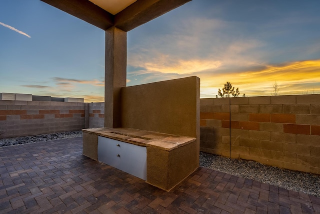 view of patio terrace at dusk