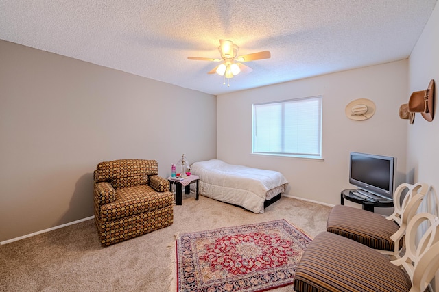 bedroom featuring carpet floors, ceiling fan, baseboards, and a textured ceiling