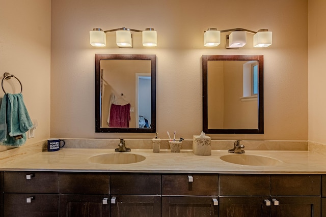 full bath featuring double vanity and a sink