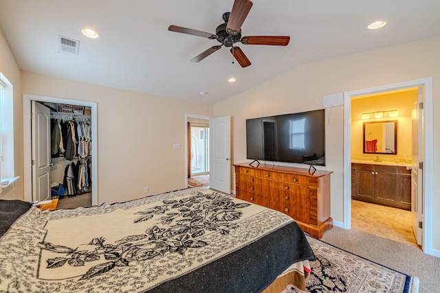 bedroom featuring recessed lighting, visible vents, light carpet, vaulted ceiling, and ensuite bath