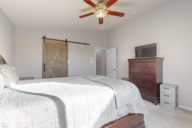 carpeted bedroom featuring ceiling fan, lofted ceiling, and a barn door