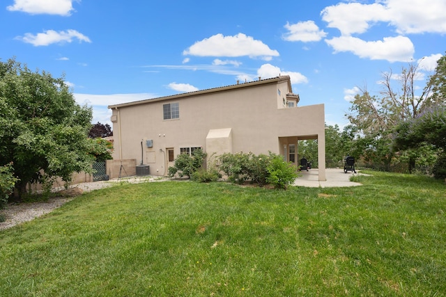 11001 Alta Dr NW, Albuquerque, NM 87114 - back of house with stucco siding, fence, a patio, a lawn, and central AC