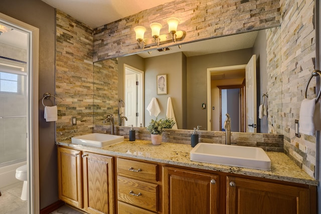11001 Alta Dr NW, Albuquerque, NM 87114 - bathroom with double vanity, visible vents, a sink, and toilet