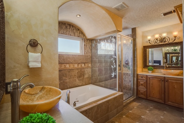 bathroom with shower with separate bathtub, vaulted ceiling, vanity, and a textured ceiling