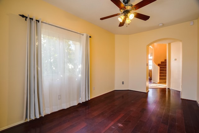 11001 Alta Dr NW, Albuquerque, NM 87114 - spare room featuring arched walkways, hardwood / wood-style flooring, stairway, and ceiling fan