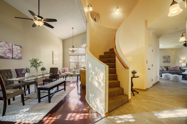 11001 Alta Dr NW, Albuquerque, NM 87114 - interior space with ceiling fan with notable chandelier, high vaulted ceiling, wood finished floors, and baseboards