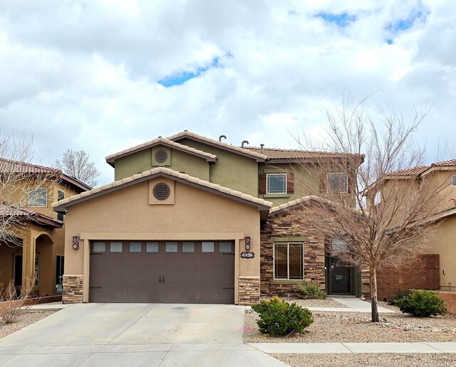 view of front of home featuring stone siding, a tiled roof, driveway, and stucco siding