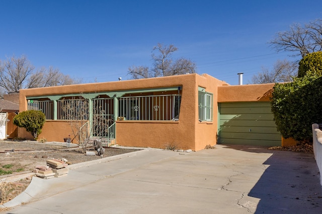 pueblo revival-style home featuring stucco siding