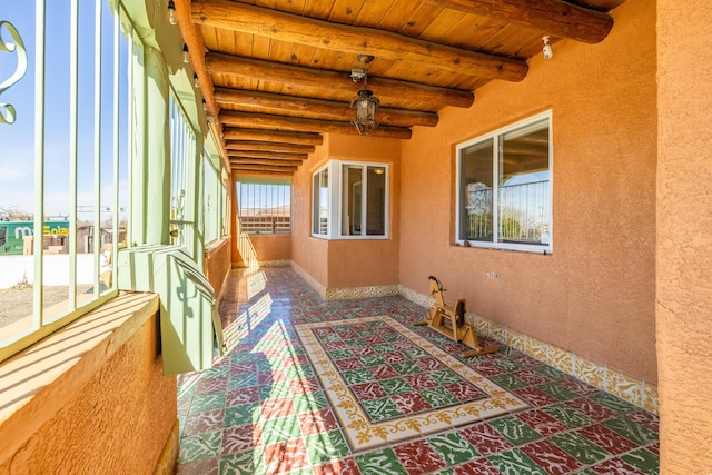 sunroom / solarium with wood ceiling and beamed ceiling