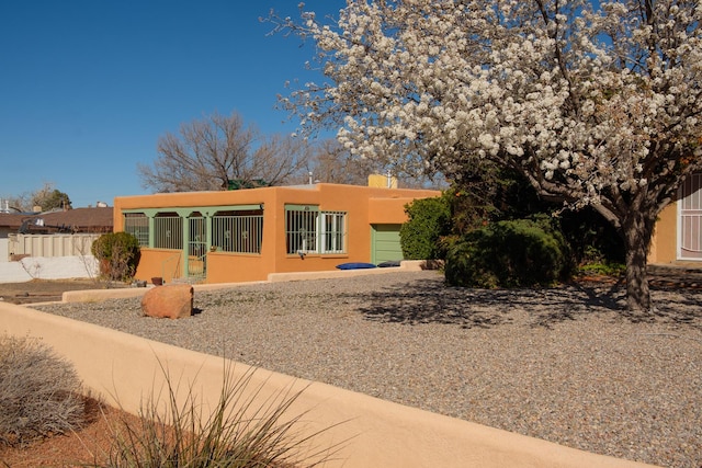 view of front of home featuring a fenced front yard and stucco siding