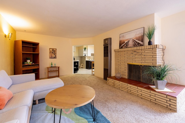 carpeted living room with a brick fireplace