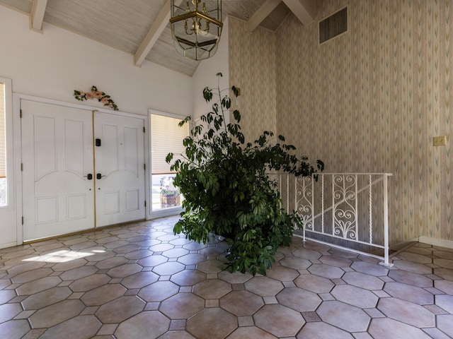 entrance foyer featuring wood ceiling, high vaulted ceiling, and beamed ceiling