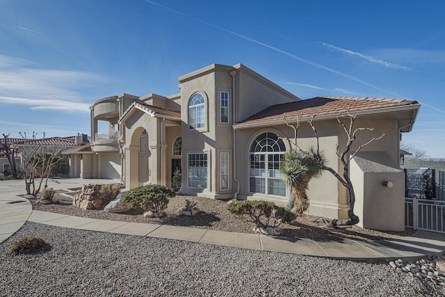 view of front of home featuring driveway, a tiled roof, and stucco siding