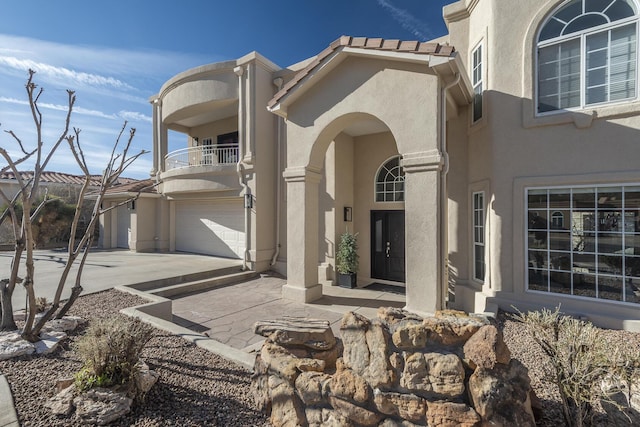 view of front of home with a balcony and stucco siding