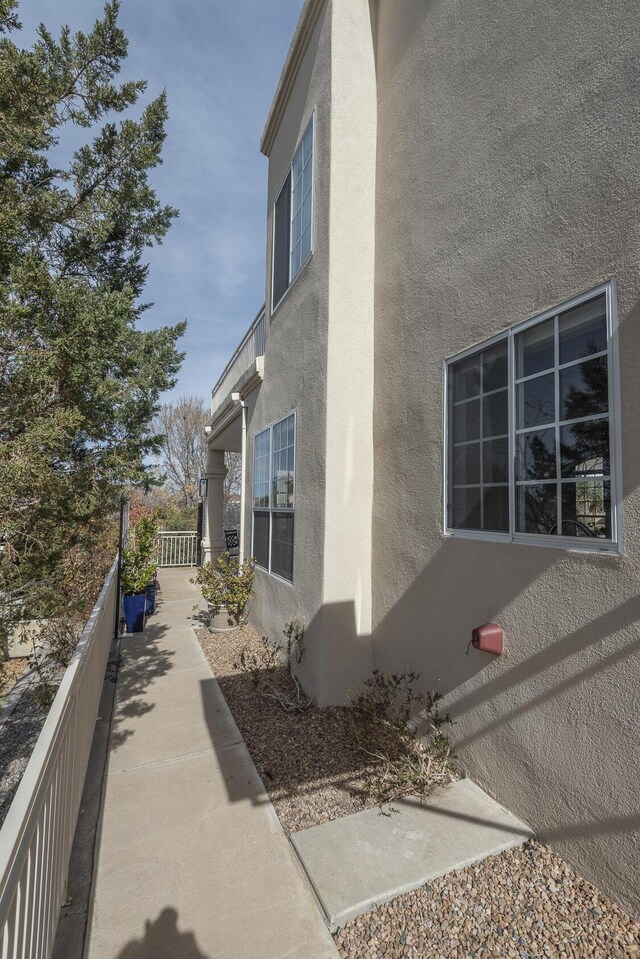 view of home's exterior featuring fence and stucco siding