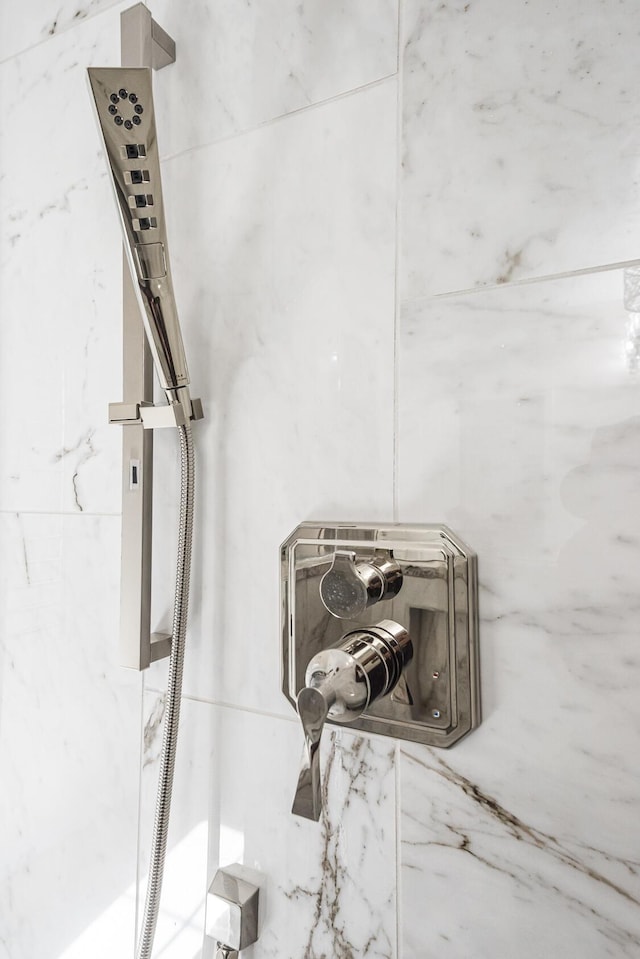 interior details featuring a tile shower