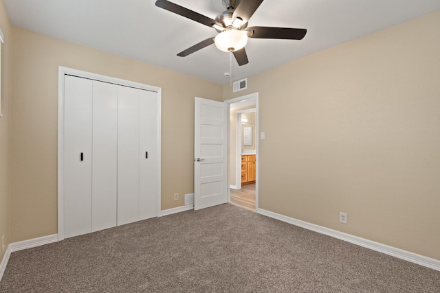 unfurnished bedroom featuring a closet, visible vents, a ceiling fan, light carpet, and baseboards