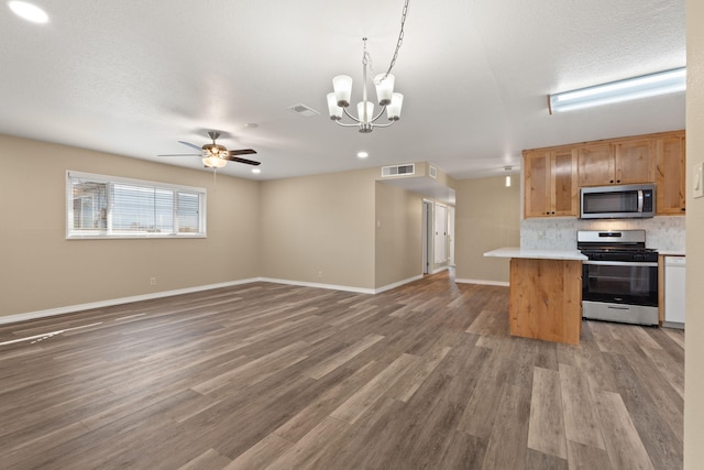 kitchen with decorative light fixtures, visible vents, light countertops, appliances with stainless steel finishes, and open floor plan