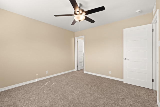 unfurnished bedroom featuring carpet, a ceiling fan, and baseboards