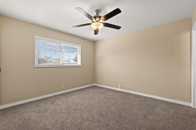 carpeted empty room featuring ceiling fan and baseboards