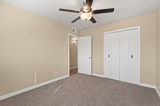 unfurnished bedroom featuring baseboards, a closet, visible vents, and carpet flooring