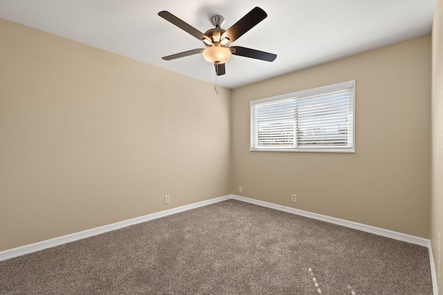 carpeted empty room featuring baseboards and a ceiling fan