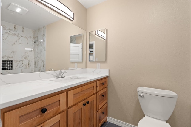 full bath featuring toilet, baseboards, walk in shower, and vanity