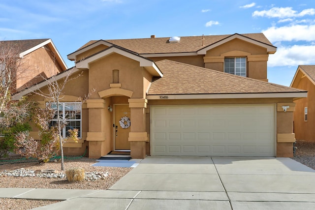 traditional home featuring an attached garage, roof with shingles, concrete driveway, and stucco siding