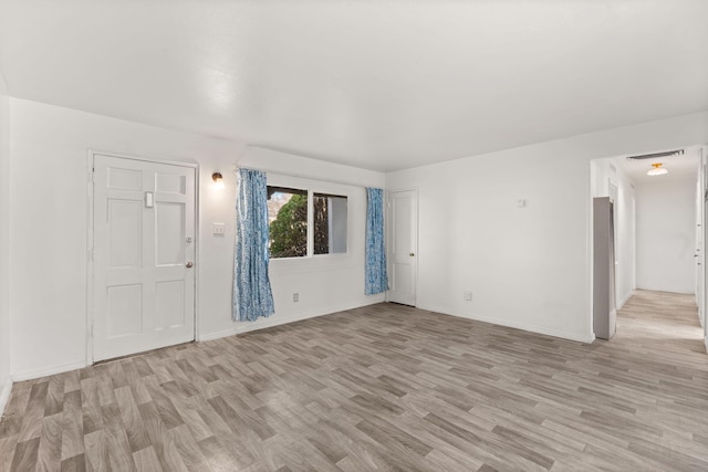 spare room featuring light wood-type flooring