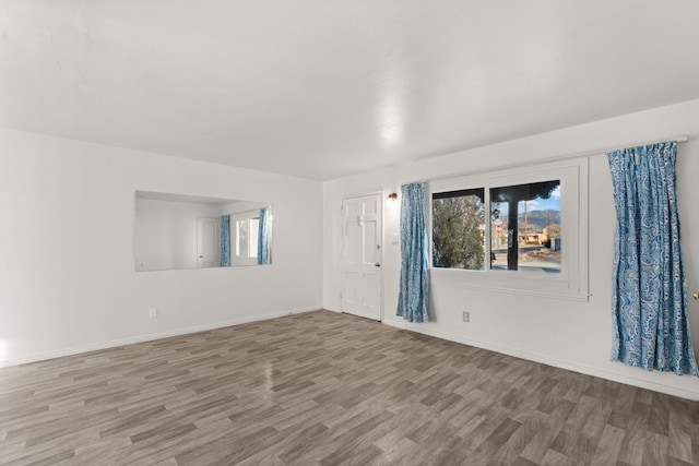 unfurnished room with hardwood / wood-style floors