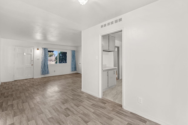 empty room with light hardwood / wood-style floors