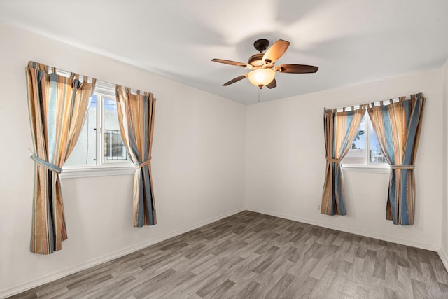 spare room featuring ceiling fan and light wood-type flooring