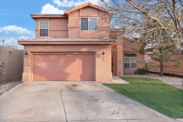 view of front of home with a garage and a front lawn