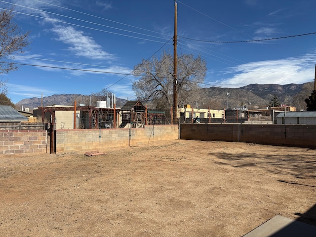 view of yard featuring a playground and a mountain view