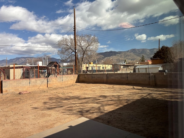 view of yard featuring a playground and a mountain view