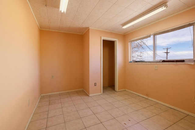 unfurnished room featuring ornamental molding and baseboards