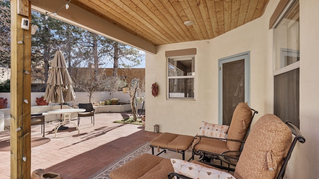 view of patio with fence and outdoor dining space