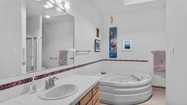 full bath with a garden tub, a stall shower, tile patterned flooring, and vanity