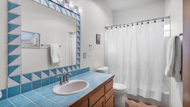 full bath with vanity, toilet, and shower / bath combo with shower curtain