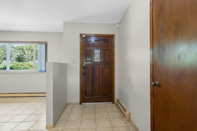 foyer featuring a baseboard heating unit and light tile patterned flooring