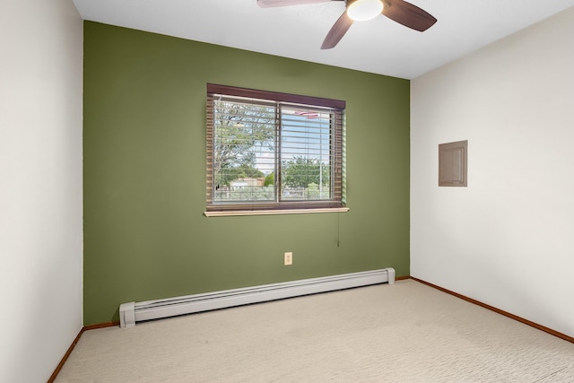 carpeted spare room featuring baseboard heating and ceiling fan