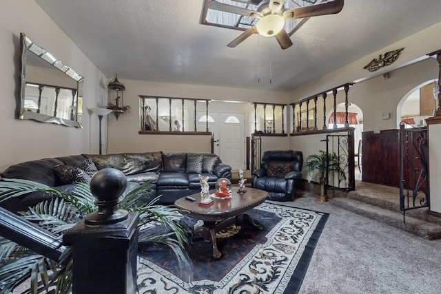 living room with carpet floors, a healthy amount of sunlight, a textured ceiling, and ceiling fan
