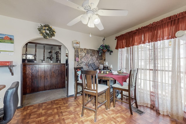 dining room with parquet floors and ceiling fan