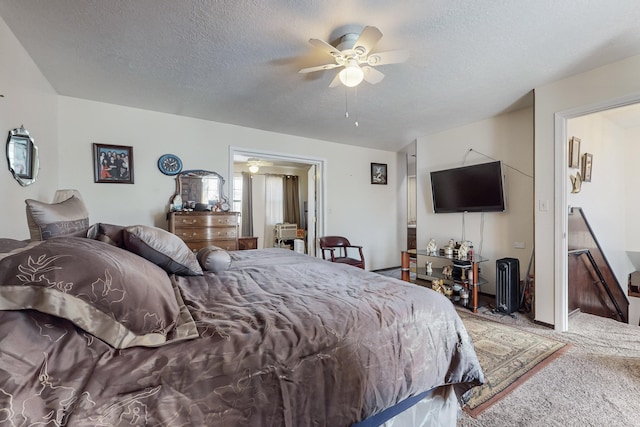 carpeted bedroom featuring ceiling fan and a textured ceiling
